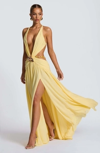 Detail of yellow halter maxi dress with high slit and decorative tortoiseshell waist buckle