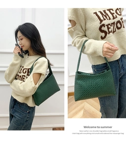 Macro view of green leather shoulder bag featuring intricate woven texture and strap details