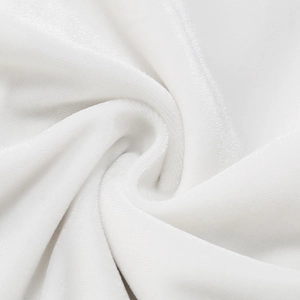 Macro shot of white velvet fabric showing soft spiral pleats and luxurious texture gloss