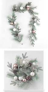 Detail of Christmas wreath with pine needles, pink baubles, and elegant mesh bow