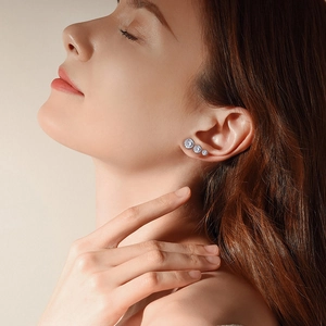 Detail shot of three graded S925 sterling silver stud earrings on a model's ear