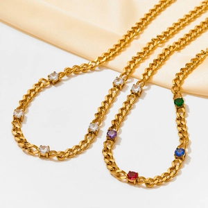 Golden Cuban chain necklace set with sparkling multicolor zircons on beige silk