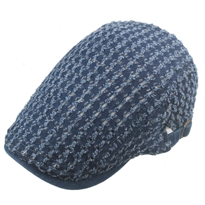 Close-up of blue denim flat cap featuring hollow woven texture and adjustable metal buckle