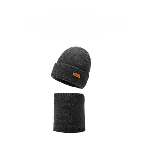 Detail view of thick grey knit beanie and neck warmer set with leather patch