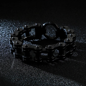 Détail macro du bracelet homme en chaîne de vélo noir avec texture métal poli
