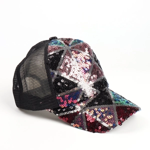 Close-up of geometric sequin patterns and breathable mesh on a stylish baseball cap