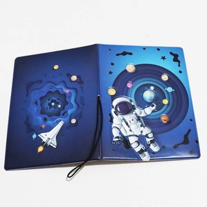 Detail view of the astronaut and solar system 3D design on blue passport holder cover