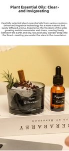 Close-up of glass aromatherapy jar with crystals, cinnamon sticks, and essential oil bottle