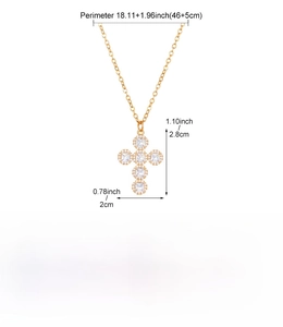 Detailed view of gold plated copper cross necklace with cubic zirconia and measurements