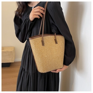 Close-up of khaki woven straw tote bag with natural texture for beach vacation style