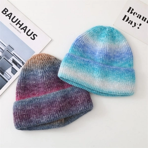 Close-up of knit beanie hats with vibrant tie-dye gradient texture and rolled edges