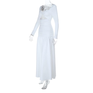 Detail of white long-sleeve maxi dress showing hollow-out bust and pleated waist design