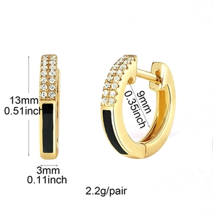 Macro shot of gold hoop earrings with black enamel and zircons showing 13mm size details