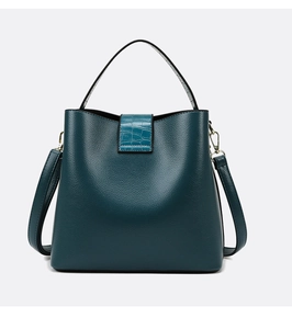 Detailed view of dark green bucket bag with lychee texture and crocodile pattern flap
