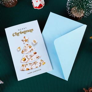 3D Christmas greeting card set with gold stamping and light blue envelope on dark background