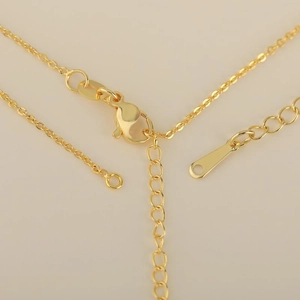 Golden necklace extension chain with lobster clasp and teardrop pendant accessory