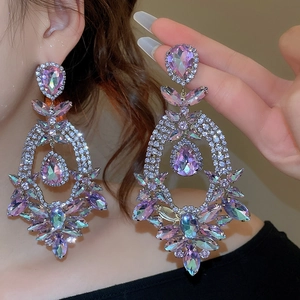 Detailed view of oversized colorful rhinestone drop earrings with sparkling teardrop stones