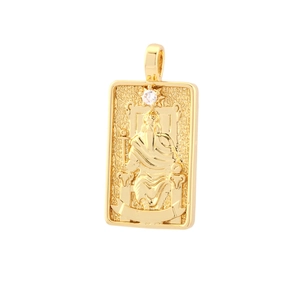 Macro shot of gold-plated square tarot pendant with embossed figure and small zircon inlay