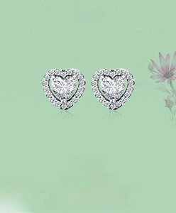 Close-up of S925 sterling silver heart studs with micro-pave zirconia and central stone