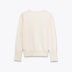 Rear view of white crew neck knit sweater showing ribbed cuffs and hem details