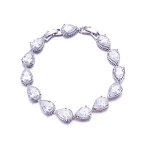 Macro shot of silver wedding bracelet featuring pear-cut cubic zirconia in a circular layout