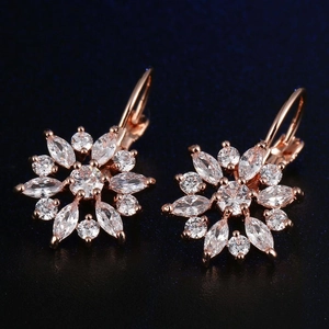 Detailed macro view of rose gold flower earrings with marquise-cut cubic zirconia crystals