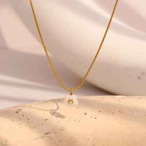 Detail of 18K gold-plated snake chain featuring a 3D white flower pendant with zircon