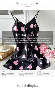 Detail of silk satin fabric with pink heart patterns and washing instructions label