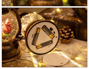 Close-up of the battery compartment and switch on a vintage bronze Christmas lantern