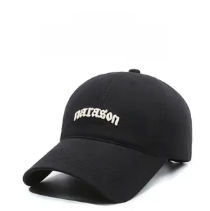 Detail of white paragon embroidery on a black cotton six-panel baseball cap