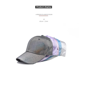 Display of stacked shimmering baseball caps in grey, purple, and blue metallic finishes.