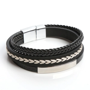 Macro shot of multi-layer black braided leather bracelet with silver magnetic clasp