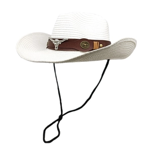 Detail of white straw cowboy hat with leather band and silver bull head ornament