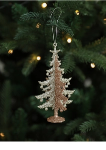 Close-up of glittery Christmas tree ornament hanging on a festive tree with warm lights