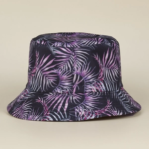 Detailed view of tropical palm leaf pattern on dark blue canvas bucket hat fabric