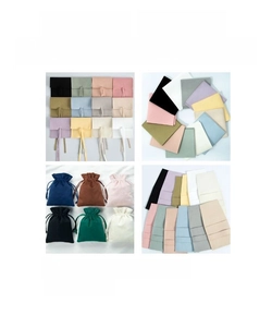 Detailed view of various velvet drawstring jewelry pouches in multiple soft colors