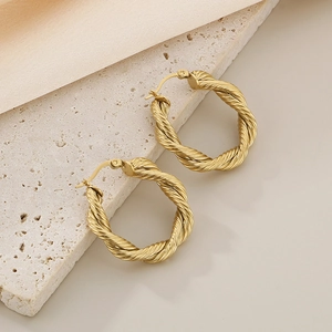 Chic 18K gold plated stainless steel twisted hoop earrings on elegant marble backdrop