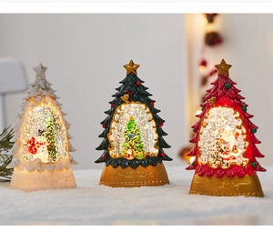 Close-up of three LED Christmas water globes with Santa, tree, and snowman figures