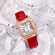 Detail of red leather strap watch with gold rhinestone case on glass and book pages