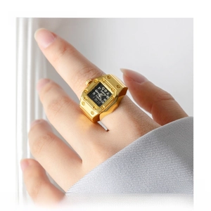 Macro shot of gold square watch ring with rivet details on hand for a vintage look