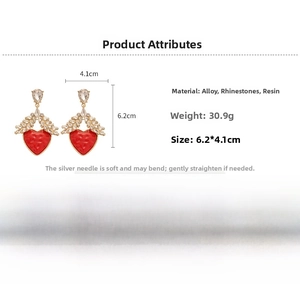 Detailed view of red resin heart earrings with crystal accents and s925 silver needles