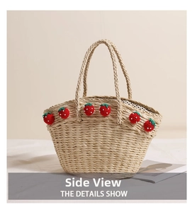 Detail view of straw tote with crochet strawberries, faux pearls, and polka dot lining