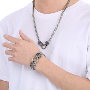 Hip hop lion head stainless steel necklace and bracelet set worn by a male model