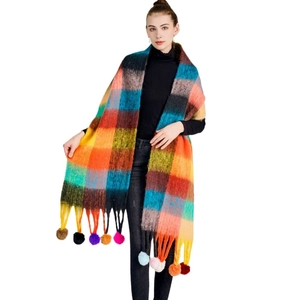 Rainbow plaid winter scarf with colorful tassel pom-poms for women on white background