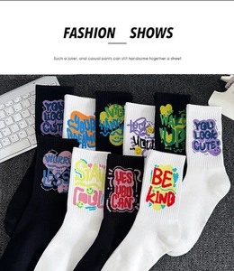 Flat lay of cotton athletic socks in black and white with colorful graffiti typography