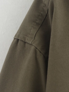 Detail of heavy canvas jacket shoulder seam with durable double-needle stitching