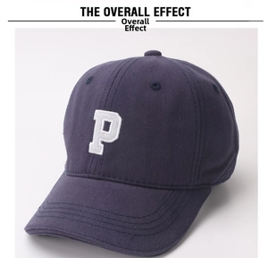 Detailed embroidery of white letter P on a navy blue cotton twill baseball cap