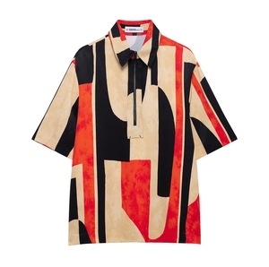Detailed flat lay of a printed polo shirt with a half-zipper and floral pattern