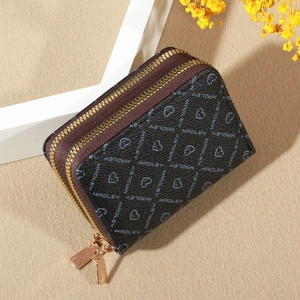 Detail of lychee pattern leather wallet with heart logo and gold zipper accents
