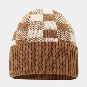 Close-up of brown and white checkered knit beanie with thick cuff and cozy texture
